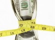 dollars squeezed by tape measure