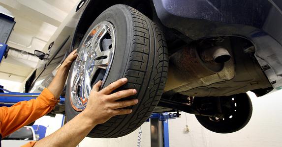 Mechanic installing new tire on vehicle